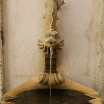 A decorative fountain featuring an intricately designed dragon perched atop its structure.