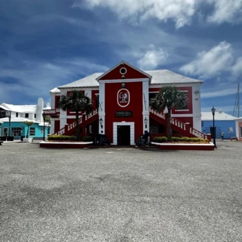 A red and white building featuring a striking red roof, showcasing a vibrant architectural design.